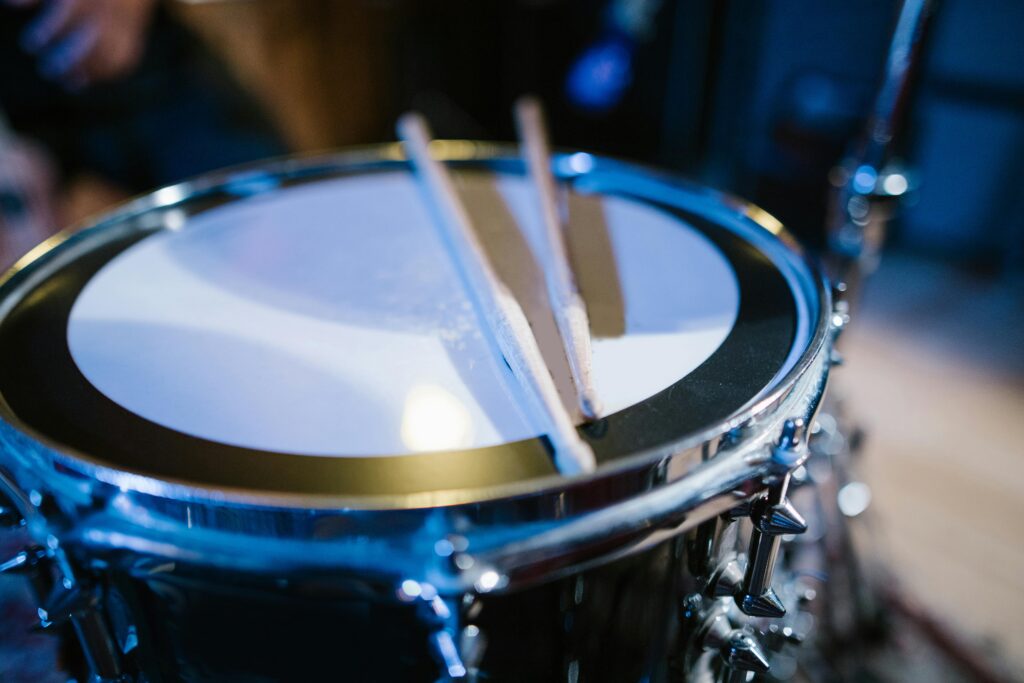 A close-up view of a snare drum and drumsticks on stage. Perfect for music and performance themes.